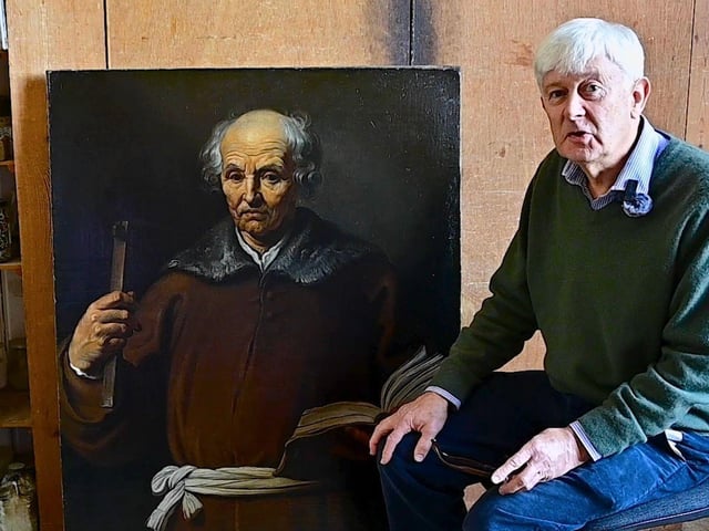 Art restorer Simon Faulkes works on the painting of Jude Thadeus