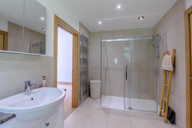 The master bedroom ensuite features a large shower and a heated towel rail.