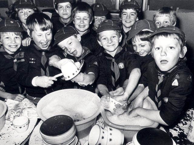 Members of the 74th Sheffield (Heeley) cub scouts, buckle down to a sponsored dish washing session at Heeley parish church hall, June 12 1979