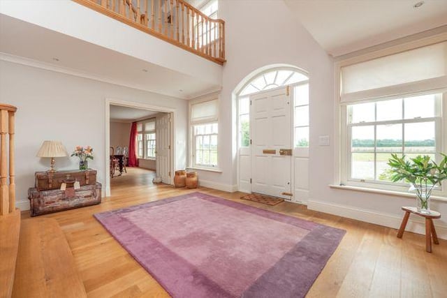 The property features a large and welcoming reception hall with oak flooring