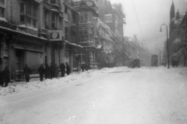 A blurry scene but it shows a blizzard in Fawcett Street in February 1947.