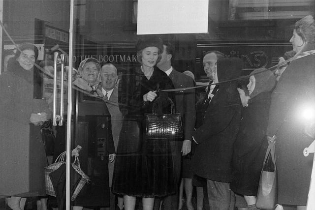 Lady Isobel Barnett congratulates the winner of a new 19" television set at the opening of a Rediffusion showroom on Dalry Road in December 1964.