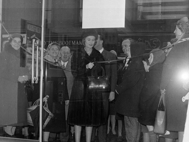 Lady Isobel Barnett congratulates the winner of a new 19" television set at the opening of a Rediffusion showroom on Dalry Road in December 1964.