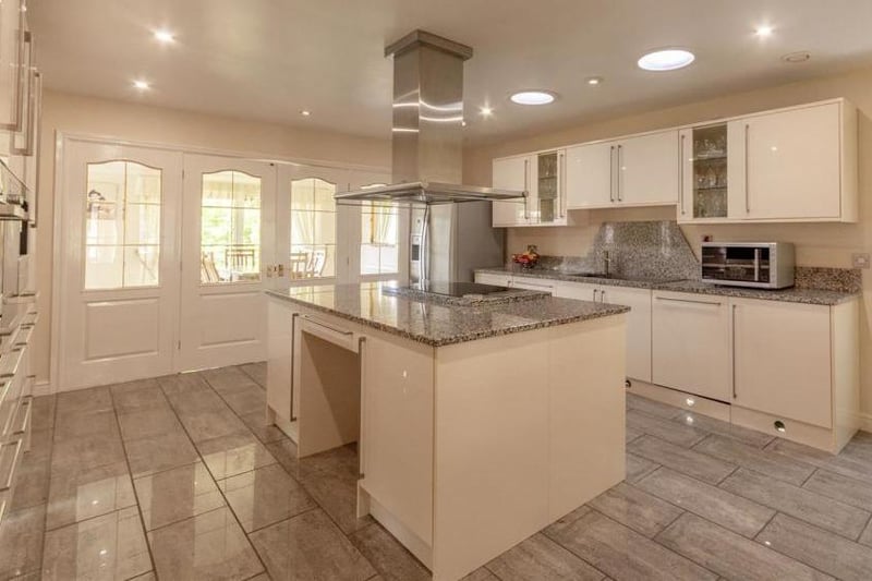 A wonderful kitchen, complete with a range of Miele appliances, gloss cabinets and units. It is complemented perfectly by its worktop and island.