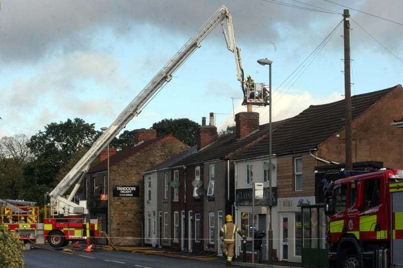 The blaze broke out on a row of terrace houses and takeaway shops