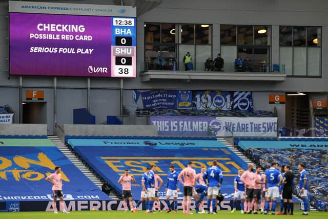 The big screen displays a VAR message resulting in a red card for John Lundstram of Sheffield United during the Premier League match between Brighton & Hove Albion and Sheffield United (Photo by Mike Hewitt/Getty Images)