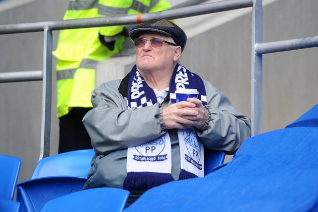 A North End supporter waits for kick-off in Cardiff