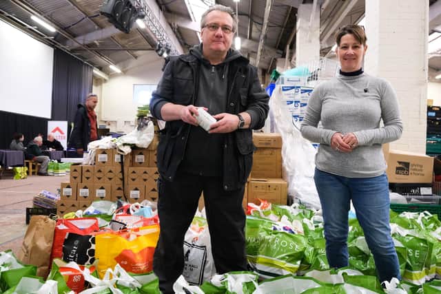 Ian Franklin and Helen Reynolds picking items for distribution to local families at the S6 Foodbank