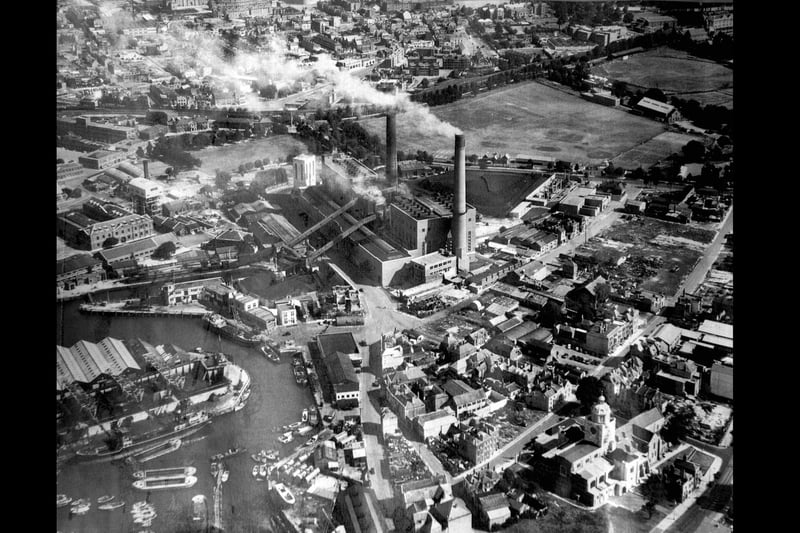 Old Portsmouth Power Station circa 1948.
To the bottom left is the Camber with the coal hoppers of Fraser & Whites the coal merchant. Unloading at the wharf is a large collier with three barges alongside.
At the pointed end of the coal wharves can just be seen the Bridge Tavern which is dwarfed by them. 
Above the Bridge Tavern is the lock for the coal barges that brought in coal for the power station.
The covered travelators for taking the coal up and over Gunwharf Road can be seen.
Above the lock are the buildings of HMS Vernon. 
To the bottom right can be seen Oyster Street which at this time  passed into White Hart Lane and since these times a block of flats have been built over it.
St Thomas Street passes behind the cathedral with many of the buildings just bomb sites. The bank now a residential building on the corner of Highbury Street can be Cleary seen.
 The east end of St Thomas's Street and Warblington Street leading into St Georges Road close by Landport Gate are both bomb sites.
 To the top right hand corner can be seen the United Services cricket ground where, up until the Rose Bowl was built, Hampshire played first class cricket.  
Above the power station chimneys the railway line from the Harbour station to Portsmouth & Southsea High Level can be seen running along its tree lined route.