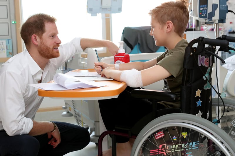 Prince Harry speaks with 11-year-old Heath Keighley during his visit to Sheffield Children's Hospital
