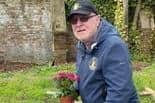Ronnie Steele, chair of the Brian Glover Blue Plaque Group at the late actor's grave in Brompton Cemetery