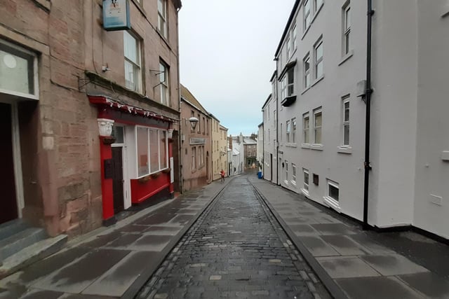 All quiet on West Street apart from a lone postwoman.