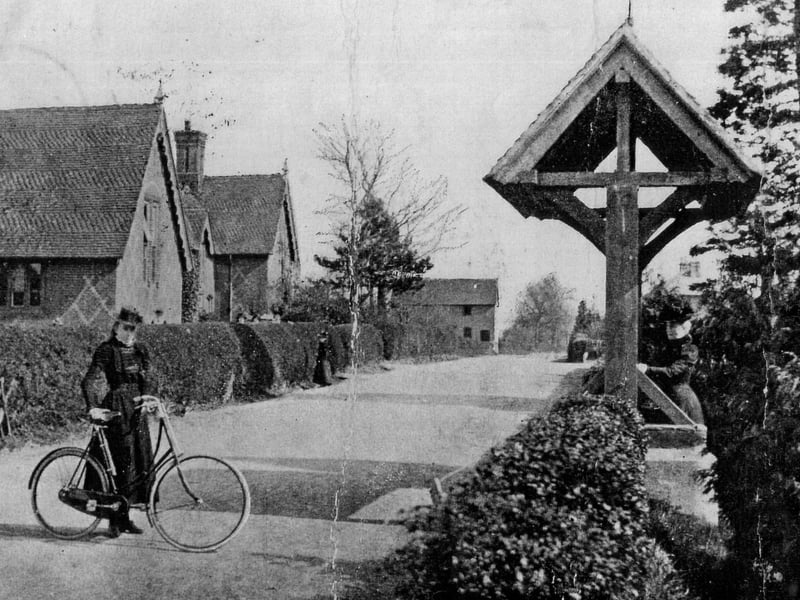 An unknown woman on a bike outside St Barnabas Church in 1904, with the village school (now Swanmore CE Primary) in the background.