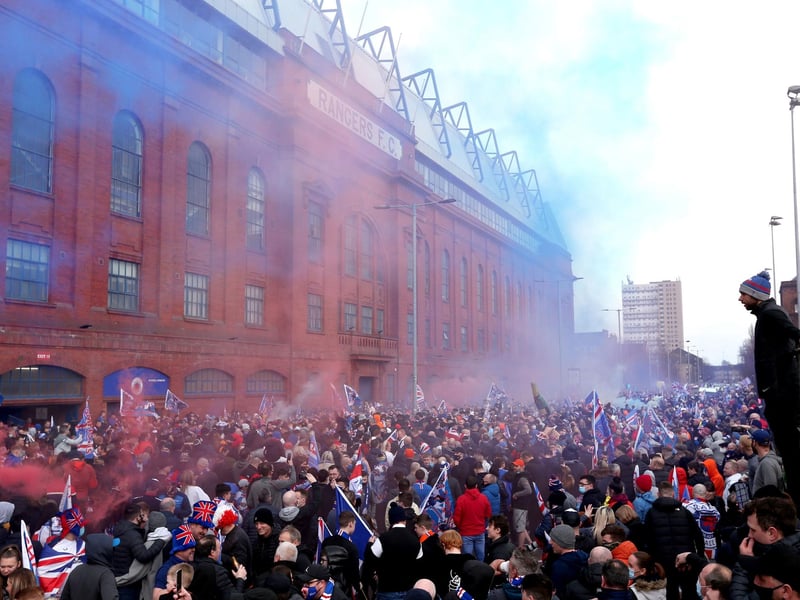 Rangers fans celebrate outside of the Ibrox Stadium after Rangers win the Scottish Premiership title.