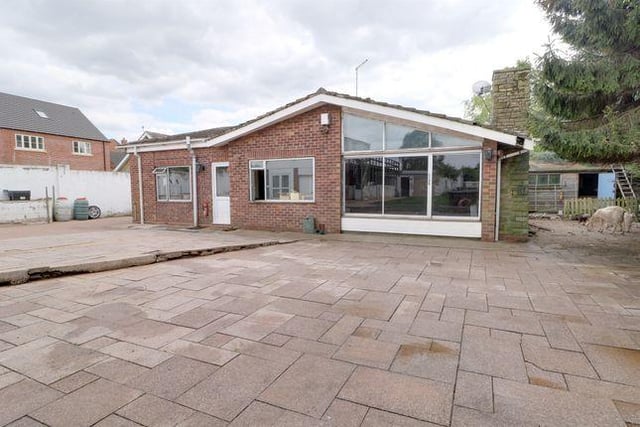 This four bedroom bungalow has planning permission granted to erect two dwellings behind the existing bungalow and an outdoor swimming pool.