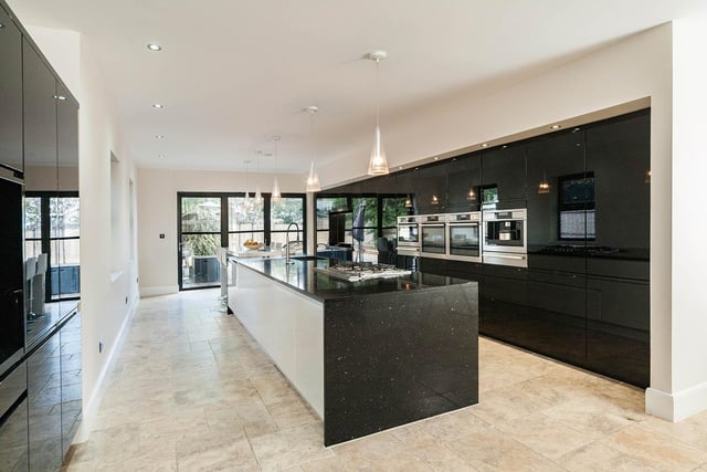 A stunning open plan dining kitchen offers a range of luxurious units and integrated appliances