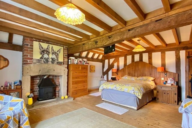 The third bedroom is large, with a feature stone fire surround and exposed brick chimney breast. It boasts fitted wardrobes and exposed beams to the ceiling.