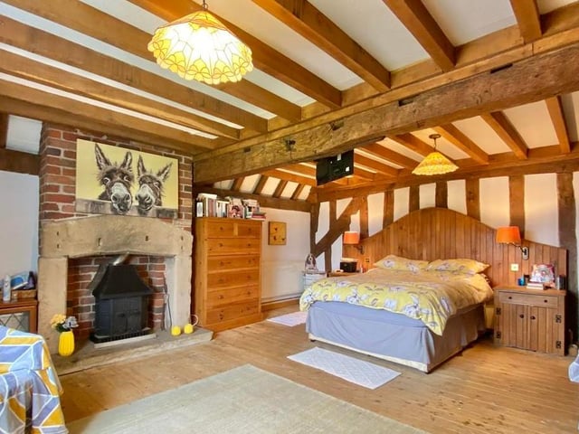 The third bedroom is large, with a feature stone fire surround and exposed brick chimney breast. It boasts fitted wardrobes and exposed beams to the ceiling.