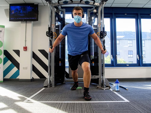 Some members are wearing face coverings while they work out.