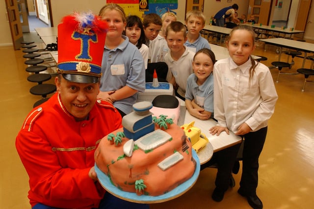 Tommy the Trumpeter presents a Tracey Island cake to the pupils of Ridgeway School in 2004 but who can tell us why?