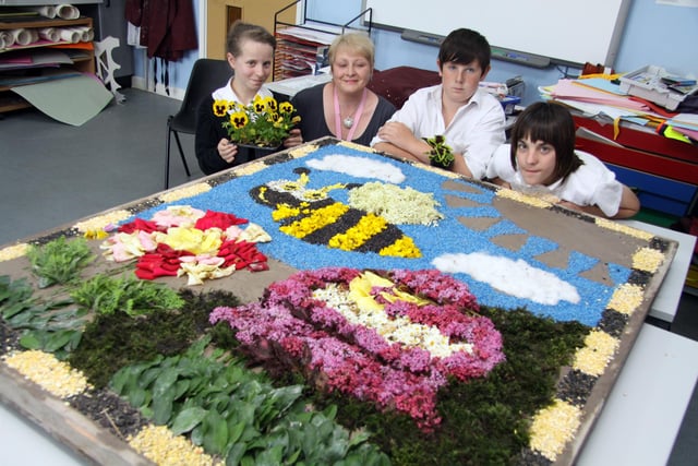 Youngsters from North East Derbyshire Support Centre make a well dressing for Old Whittington. Shelby Potts, 12, Mrs Sharon Robinson, Brandon Culley, and chris Goodman, 14 are all pictured back in 2013