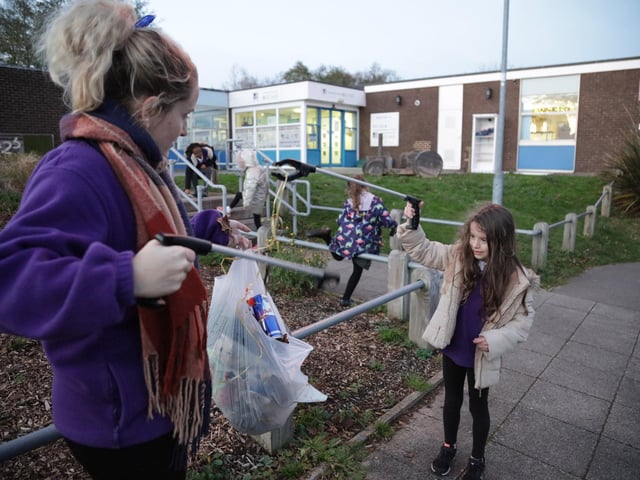 Belinda and Sophia Lipscomb picking litter