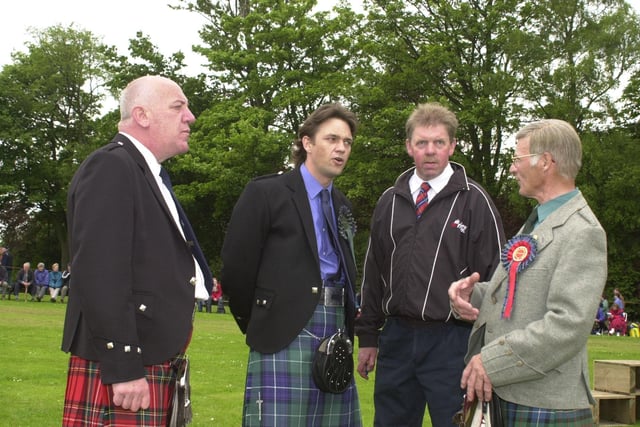 Dougray resplendent in Highland dress chats with games officials