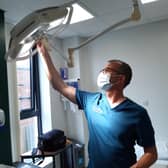 Dr Anthony Gore adjusts the light in the room of the modern Woodseats Health Centre which can be used for minor operations