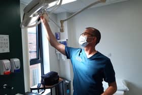 Dr Anthony Gore adjusts the light in the room of the modern Woodseats Health Centre which can be used for minor operations