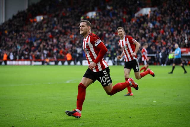 SHEFFIELD, ENGLAND - FEBRUARY 09: Billy Sharp of Sheffield United celebrates scoring his team's first goal during the Premier League match between Sheffield United and AFC Bournemouth  at Bramall Lane on February 09, 2020 in Sheffield, United Kingdom. (Photo by Richard Heathcote/Getty Images)