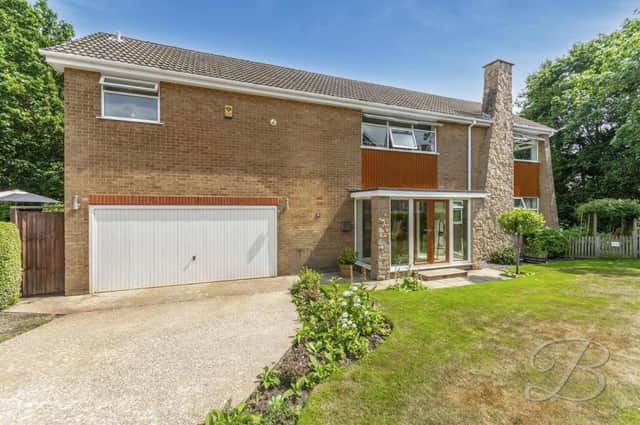 The four-bedroom, detached home at The Links in Mansfield, described as "exceptional" and "much-cherished". The frontage features a neat lawn with decorative shrubs, a spacious driveway and a double integrated garage that could also be used as a workshop.