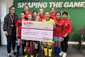 Ellie Matthew of St Luke's (left) receives the cheque from the young players