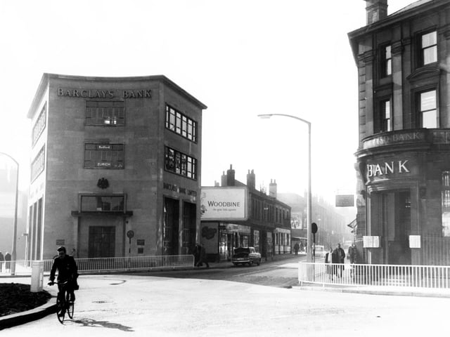 A lone cyclist at the bottom of The Moor, Sheffield city centre, in 1959, with Barclays Bank in the background and the Midland Bank on the right