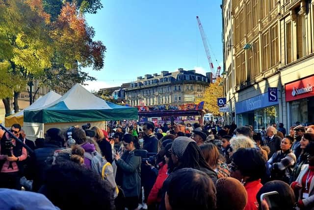 Crowds gather to watch performances during the African-Caribbean market last month