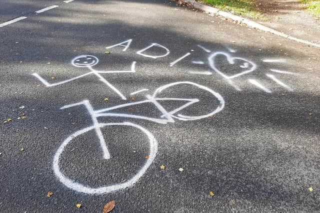 A memorial to 'much-loved' Adrian Lane at the scene.