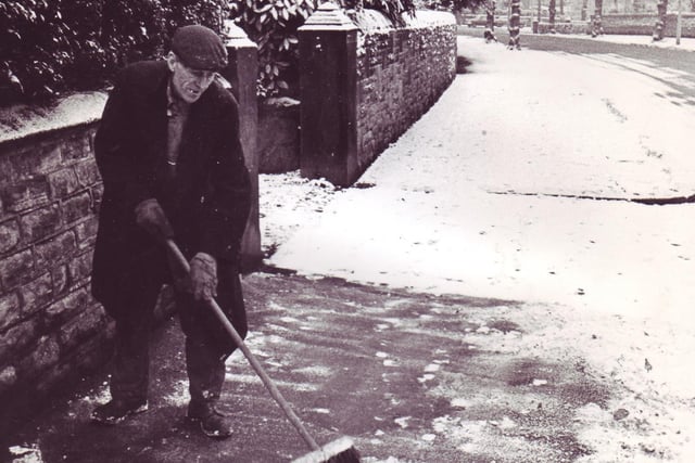 A man sweeps the snow from the footpath in Kenwood Road, Nether Edge
December 1969