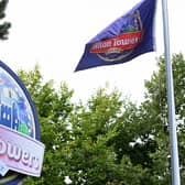 A logo sits on a sign outside the entrance to the Alton Towers theme park, operated by Merlin Entertainments, in Staffordshire, central England on August 27, 2015. A total of 16 people required medical attention after the rollercoaster carriage they were in hit an empty carriage on The Smiler ride at Alton Towers, in central England, on June 2, 2015.    AFP PHOTO/PAUL ELLIS        (Photo credit should read PAUL ELLIS/AFP via Getty Images)