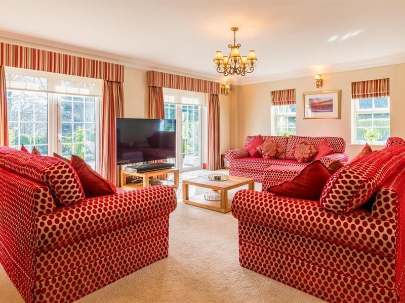 The impressive drawing room provides another space for relaxing and entertaining, and includes a curved bay window with French doors on either side which provide access to the sun terrace.