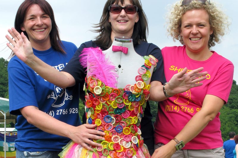 Sarah Berry (centre) models the 'Lady Pride' condom dress with colleagues from the Genito Urinary Medicine Clinic Kirsty Ellis (left) Laura Tiernan (right) and Julie Barrett (under dress) at Sheffield Pride 2010