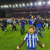 Sheffield Wednesday fan Harris Battle celebrates on the pitch after team's outstanding comeback in the play-off semi-final against Peterborough United.