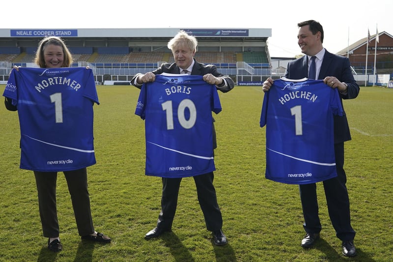 Jill Mortimer, Conservative party candidate for Hartlepool, Britain's Prime Minister Boris Johnson, and Ben Houchen, Tees Valley Mayor, from left,  are presented with personalized Hartlepool United soccer team shirts during a visit to the Hartlepool United Football Club, in Hartlepool, England ahead of the May 6 by-election, Friday April 23, 2021.