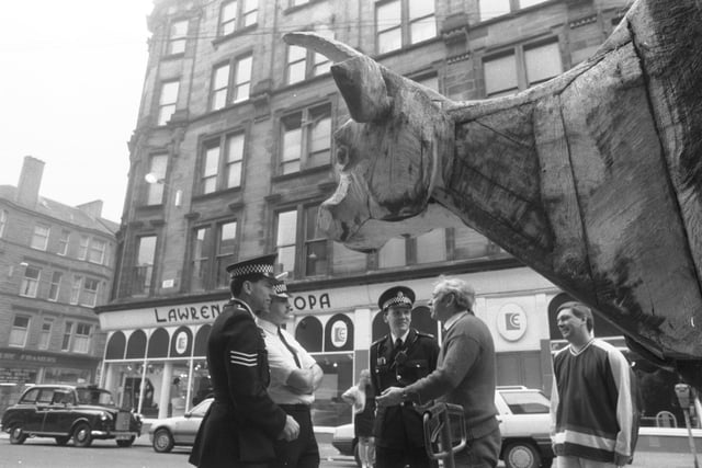 Police interview an employee of S Tuck Ltd beside an 8 ft high sculpture of an ox, bound for the Glasgow Garden Festival, April 1988.