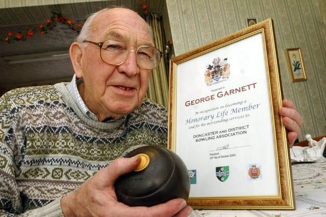 George Garnett pictured with his life time member certificate from the District Bowling Association, 2004.