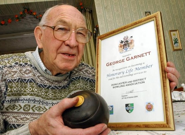 George Garnett pictured with his life time member certificate from the District Bowling Association, 2004.