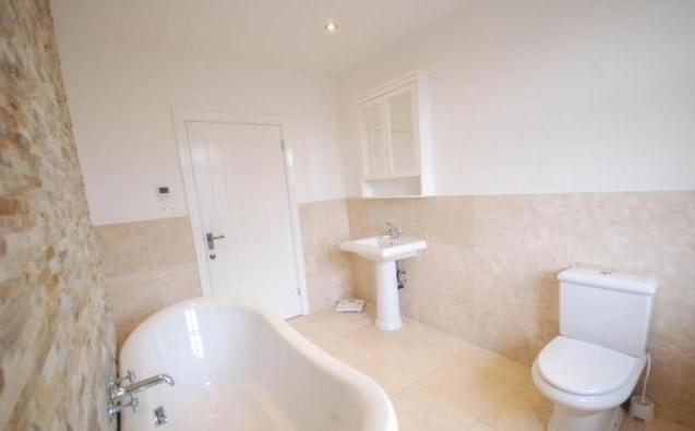 The family bathroom is of a modern standard, and fitted with a Tub style bath