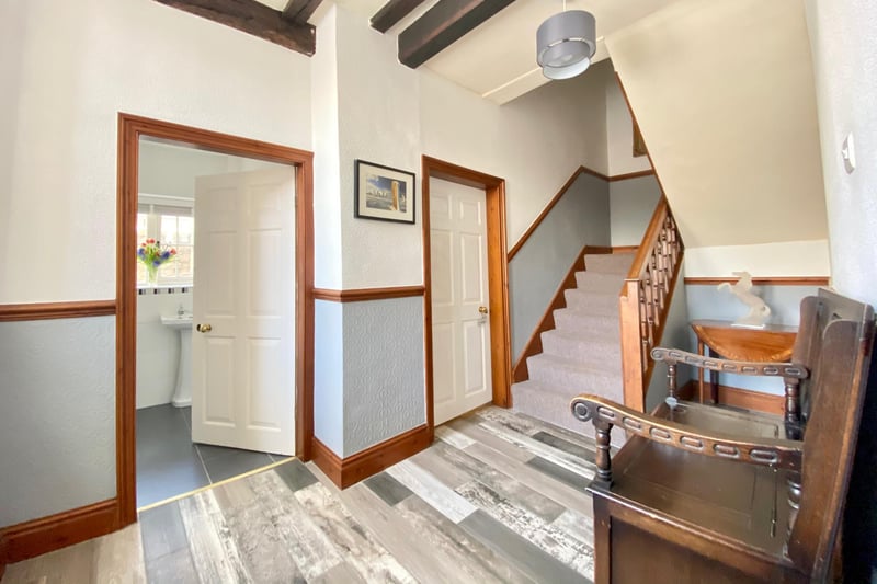 Exposed original ceiling beams and a solid wood, handmade turning staircase leads to the first floor.