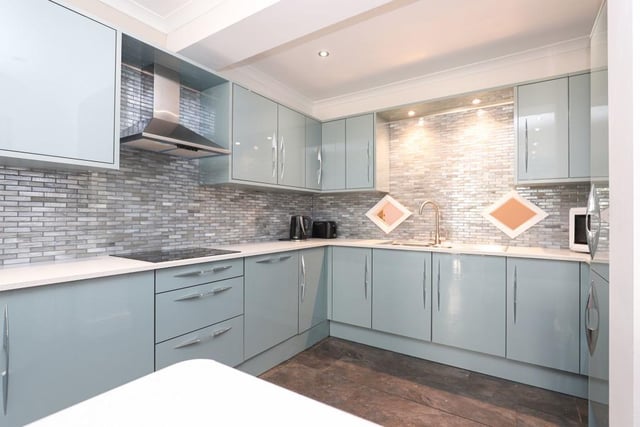 The recently fitted open-plan kitchen with integrated appliances is bright and spacious.