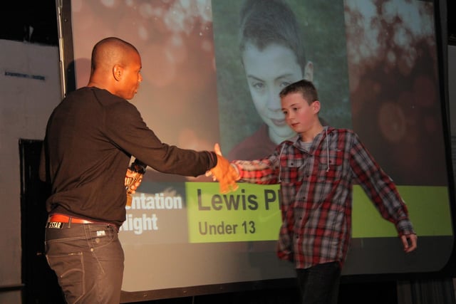 An U13 player comes forward to celebrate a successful season for the Warriors. Are you, or do you know, Lewis P?