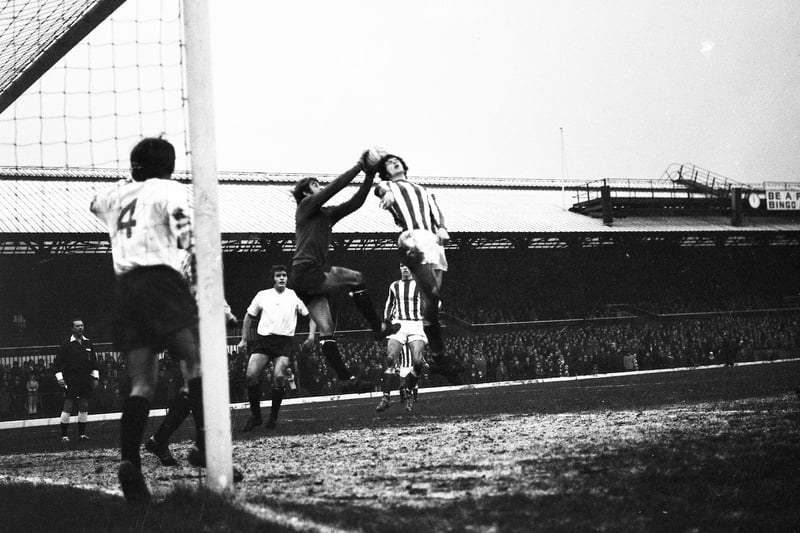 Centre half Richie Pitt challenges for a left wing corner, but goal keeper John Dunn goes up top snatch the  ball from his head in this Sunderland match with Charlton Athletic which the Black Cats won 3-0.