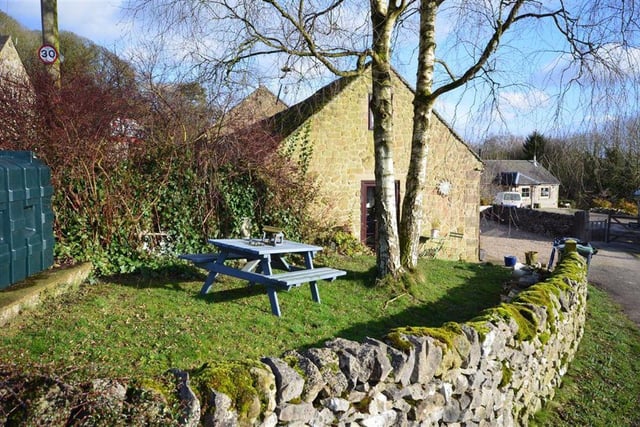 There is a lawned garden to side which is fully enclosed by stone walling.